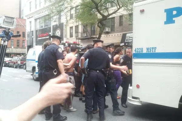 Five protestors are placed inside a police wagon near Union Square earlier today